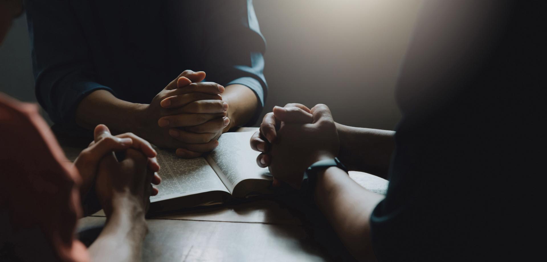 Christians and Bible study concept. Group of Christians holding hands praying worshiping belief and sharing the gospel. spirituality and religion. Peace, hope.