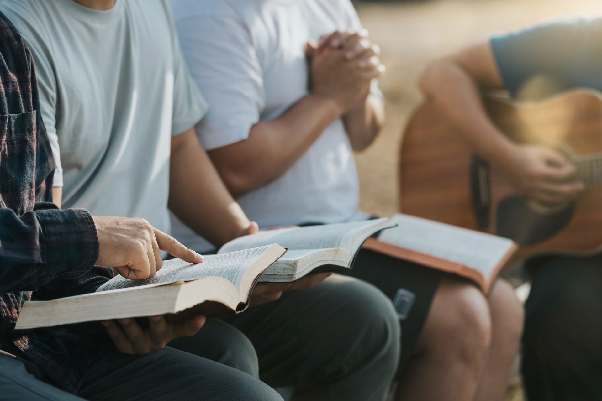 Christian Bible Study Concepts. Christian friend groups read and study the bible together in the park. sharing the gospel with a friend. followers are learning the word of God. praying to God.